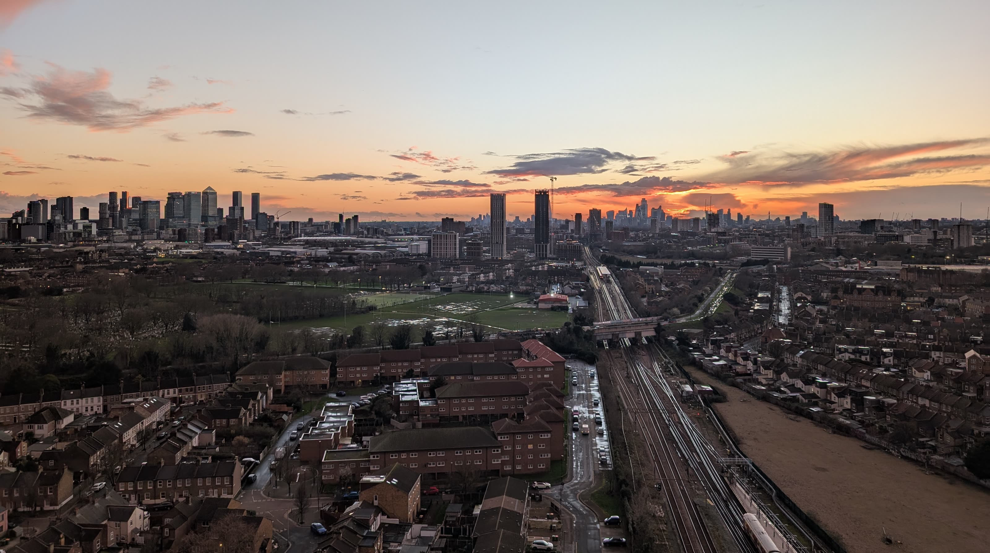 East London at sunset, looking across Plaistow and Canning Town towards Canary Wharf and the City